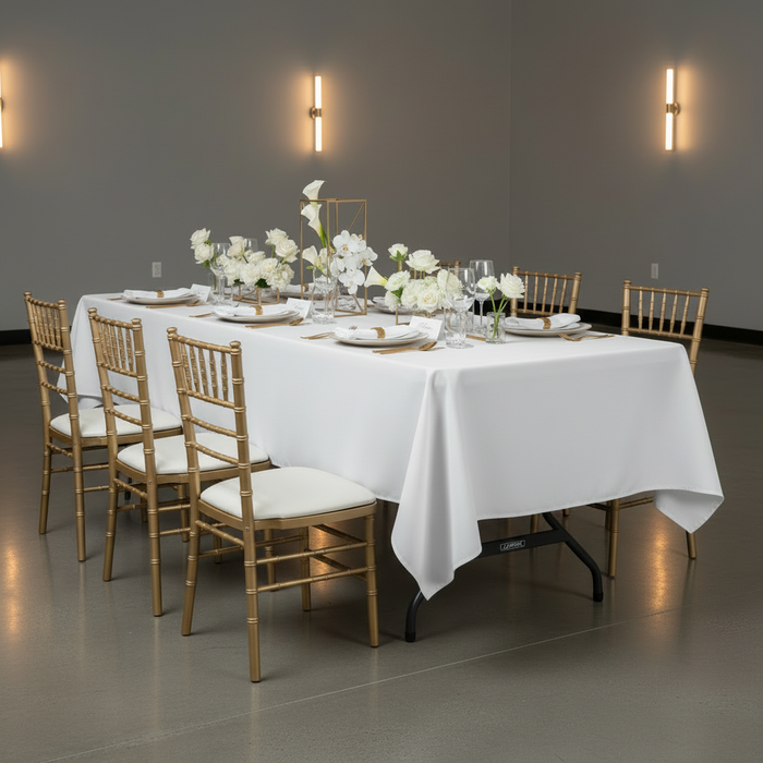 60"x120" Rectangular Premium Polyester Tablecloth - White for corporate gala with white dinner plate and gold chiavari chairs