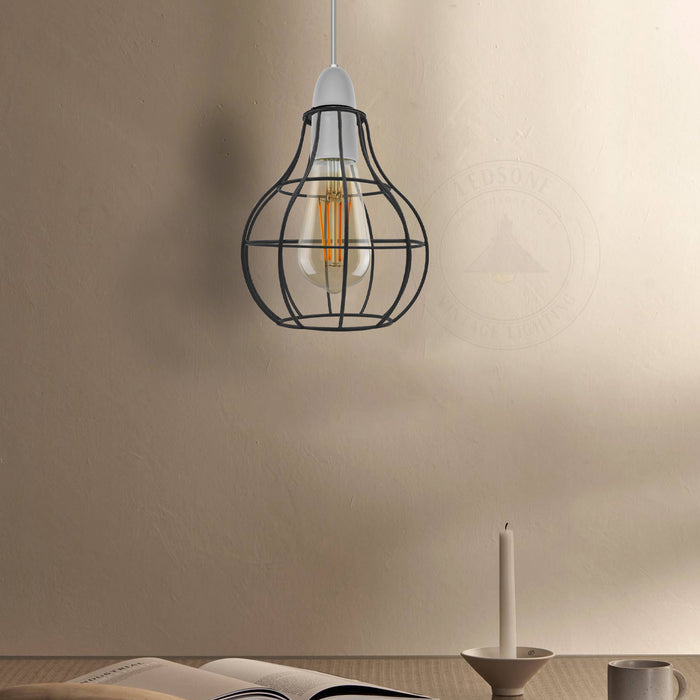 Vintage style black wire light guard hanging in a modern kitchen or living room setting
