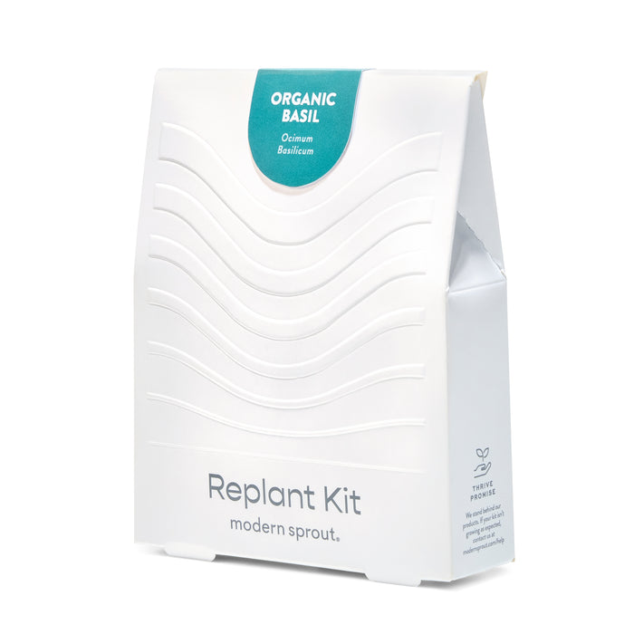 White packaging of the Immersion Hydroponic Replant Kit featuring organic basil, designed for easy indoor gardening.