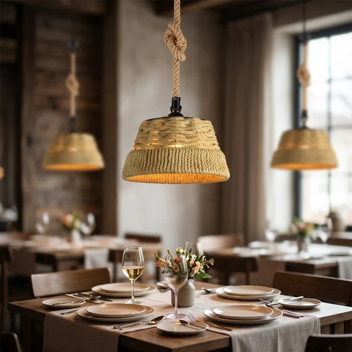 Dining room with rustic pendant lights and set tables.