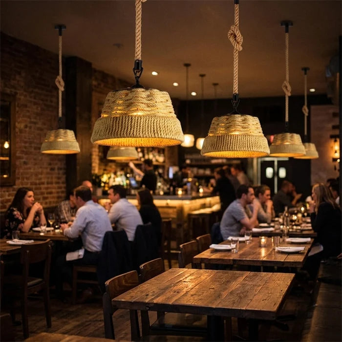 Dining area with wooden tables and wicker pendant lights in a restaurant.