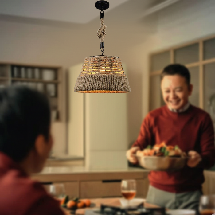 Person holding a bowl of fruit in a kitchen with a textured pendant light.