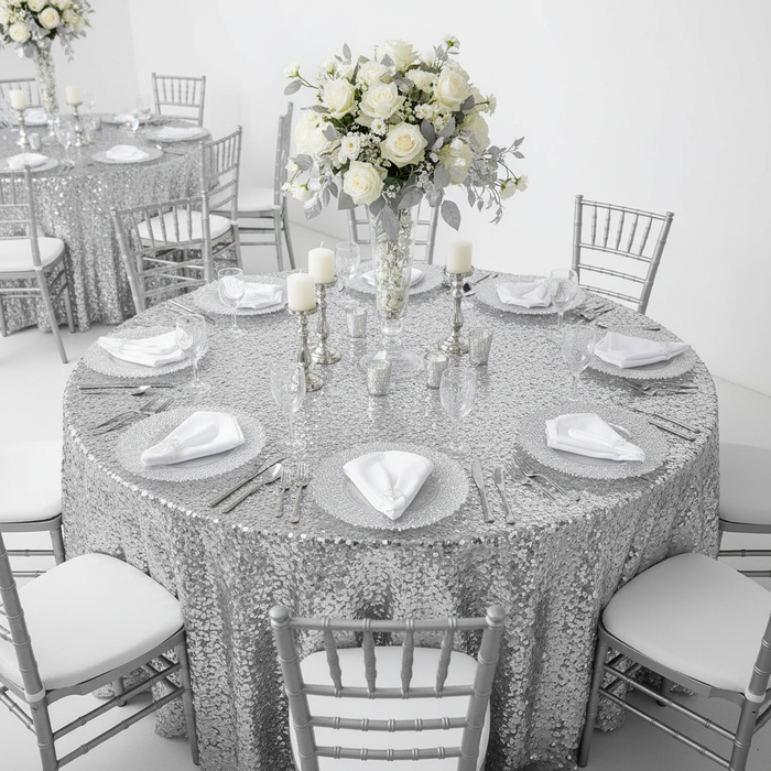 Large Payette Sequin Round 120" Tablecloth - Silver with Silver Chiavari Chairs.