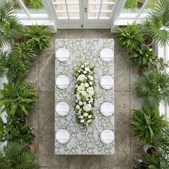 birdseye of the Vintage Lace Print Scuba Rectangular Tablecloth Olive Green/White paired with white dinnerware, wine goblets and white floral centerpieces